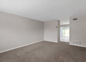 Thumbnail 62 of 69 - an empty living room with carpet and white walls