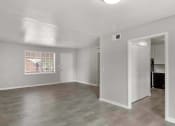Thumbnail 29 of 69 - an empty living room with white walls and a window