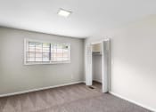 Thumbnail 12 of 69 - an empty bedroom with a window and a closet