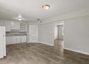 Thumbnail 42 of 69 - the living room and kitchen of an apartment with white cabinets and white appliances