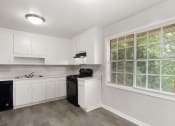 Thumbnail 22 of 69 - an empty kitchen with white cabinets and a large window