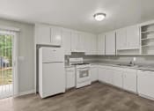 Thumbnail 39 of 69 - an empty kitchen with white cabinets and appliances and a white refrigerator