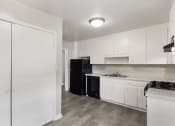 Thumbnail 19 of 69 - a kitchen with white cabinets and a black refrigerator