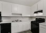 Thumbnail 31 of 69 - an all white kitchen with black appliances and white cabinets