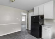 Thumbnail 17 of 69 - an empty kitchen with black refrigerator and white cabinets