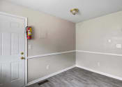 Thumbnail 18 of 69 - an empty room with a door and a fire hydrant on the wall