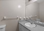 Thumbnail 57 of 69 - a bathroom with a sink and toilet and a mirror