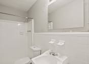 Thumbnail 35 of 69 - a white bathroom with a sink and a mirror and a toilet