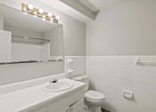 Thumbnail 48 of 69 - a bathroom with a sink toilet and a mirror