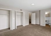 Thumbnail 55 of 69 - an empty bedroom with three closets and a bathroom