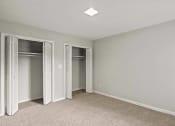 Thumbnail 44 of 69 - an empty bedroom with two closets and a carpeted floor