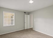 Thumbnail 37 of 69 - an empty bedroom with a window and a door to a closet