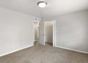 Thumbnail 25 of 69 - a bedroom with white walls and carpet and a door to a closet