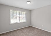 Thumbnail 66 of 69 - an empty bedroom with a window and carpeting