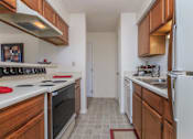 Thumbnail 2 of 37 - A kitchen with white appliances and wooden cabinets.