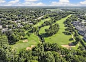 Thumbnail 1 of 53 - A golf course surrounded by houses.