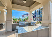 Thumbnail 22 of 38 - A kitchen area with a grill and a countertop.