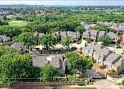 Thumbnail 51 of 53 - A residential area with houses and greenery.