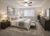 Thumbnail 5 of 28 - A bedroom with a large bed, a bench, and a ceiling fan.