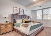 Thumbnail 10 of 38 - A bedroom with a large bed, a dresser, and a nightstand.