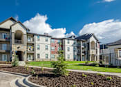 Thumbnail 31 of 38 - Apartment complex with a mix of modern and traditional architecture.