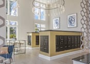 Thumbnail 17 of 18 - A modern interior with a reception desk and hanging lights.