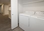 Thumbnail 12 of 28 - A white bed with a white mattress and pillow is in a room with a white wall and a white door.