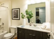 Thumbnail 11 of 20 - a bathroom with a sink and a toilet and a shower