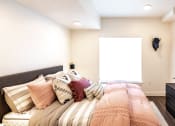 Thumbnail 13 of 20 - a bedroom with a bed and a dresser and a window