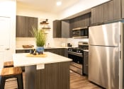Thumbnail 4 of 20 - a kitchen with stainless steel appliances and a white counter top