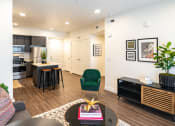 Thumbnail 9 of 20 - a living room and kitchen with a dining area and a table