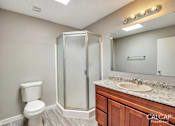 Thumbnail 15 of 18 - A bathroom with a toilet, sink, and shower.