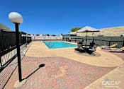 Thumbnail 4 of 18 - A pool area with a black fence and a pool table.