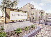 Thumbnail 13 of 13 - A sign for New Horizons Apartments is displayed in front of a building.