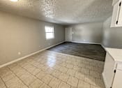 Thumbnail 16 of 27 - A room with a tiled floor and a window.