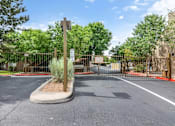 Thumbnail 21 of 28 - A parking lot with a sign and a gate.