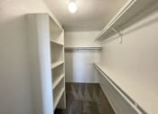 Thumbnail 8 of 28 - A long white hallway with a light on the ceiling.