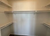 Thumbnail 9 of 28 - Empty white shelves in a room.