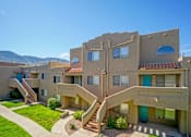 Thumbnail 19 of 28 - Apartment complex with a mountain in the background.