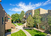 Thumbnail 22 of 28 - A sunny day in a courtyard surrounded by buildings.
