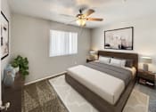 Thumbnail 6 of 28 - A bedroom with a large bed and a ceiling fan.