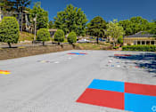 Thumbnail 3 of 19 - A road with a red, white and blue square painted on it.