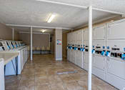 Thumbnail 4 of 19 - A laundry room with washers and dryers.