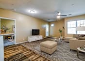 Thumbnail 3 of 20 - A living room with a flat screen TV and a couch.