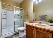 Thumbnail 7 of 20 - A bathroom with a toilet, sink, and shower.