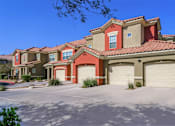 Thumbnail 10 of 20 - A row of houses with red roofs and garages.