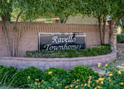 Thumbnail 14 of 20 - A sign that says Ravello Townhomes is surrounded by plants and trees.