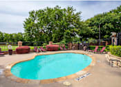 Thumbnail 48 of 53 - A small pool surrounded by trees and chairs.