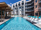 Thumbnail 15 of 21 - a swimming pool with lounge chairs next to an apartment buildingat Sterling Nashville West Apartments, Nashville, TN