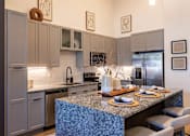Thumbnail 6 of 21 - a kitchen with stainless steel appliances and a granite counter topat Sterling Nashville West Apartments, Tennessee, 37209